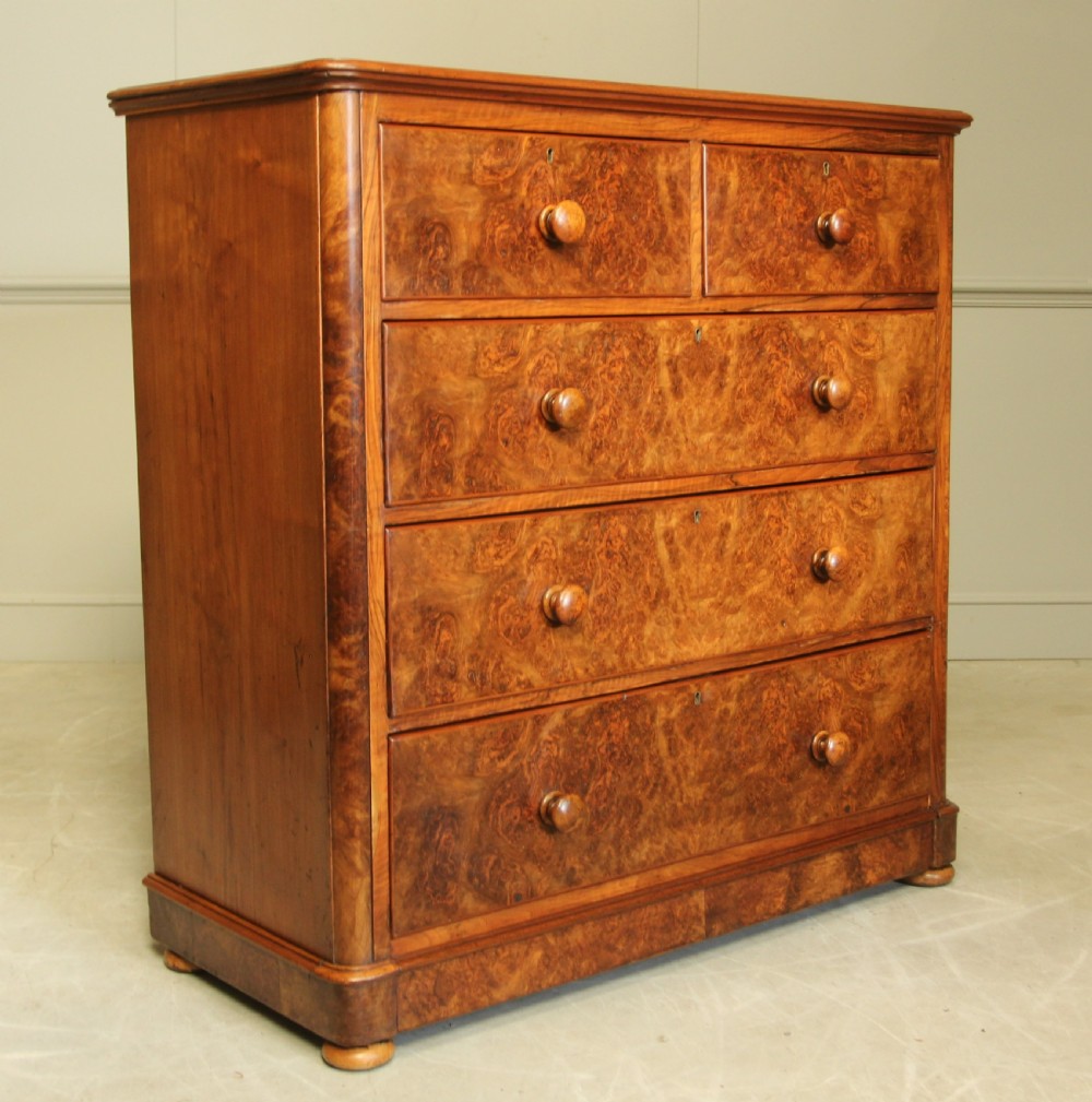 A VICTORIAN BURR WALNUT CHEST OF DRAWERS.