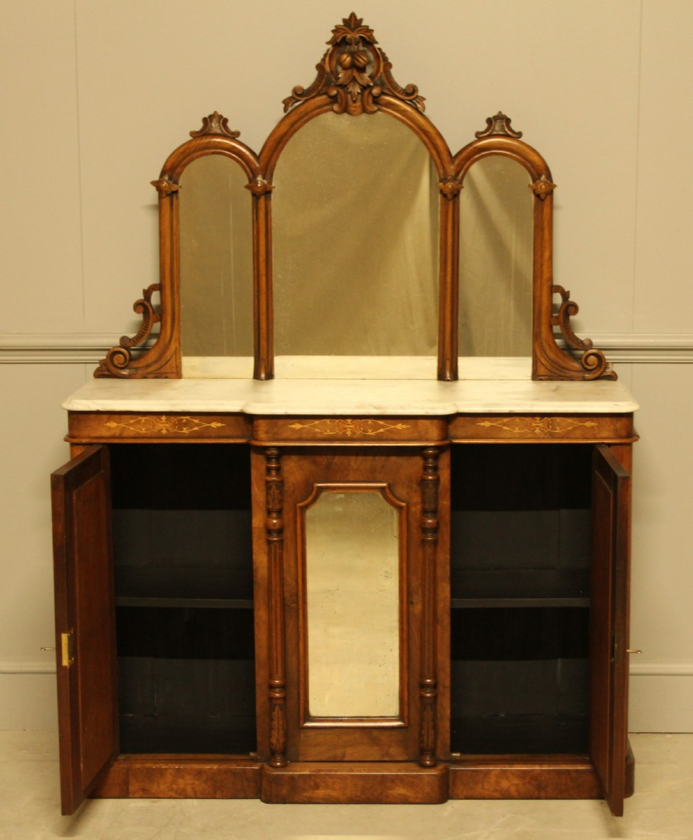A Victorian burr walnut credenza with a white marble top, arched tri-fold mirror back, and three mirrored cabinet doors below. View X