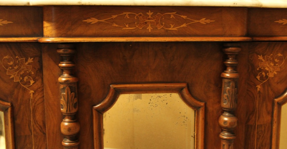A Victorian burr walnut credenza with a white marble top, arched tri-fold mirror back, and three mirrored cabinet doors below. View XI