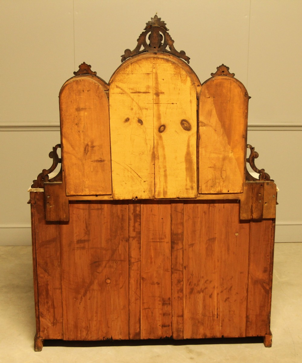 A Victorian burr walnut credenza with a white marble top, arched tri-fold mirror back, and three mirrored cabinet doors below. View XII
