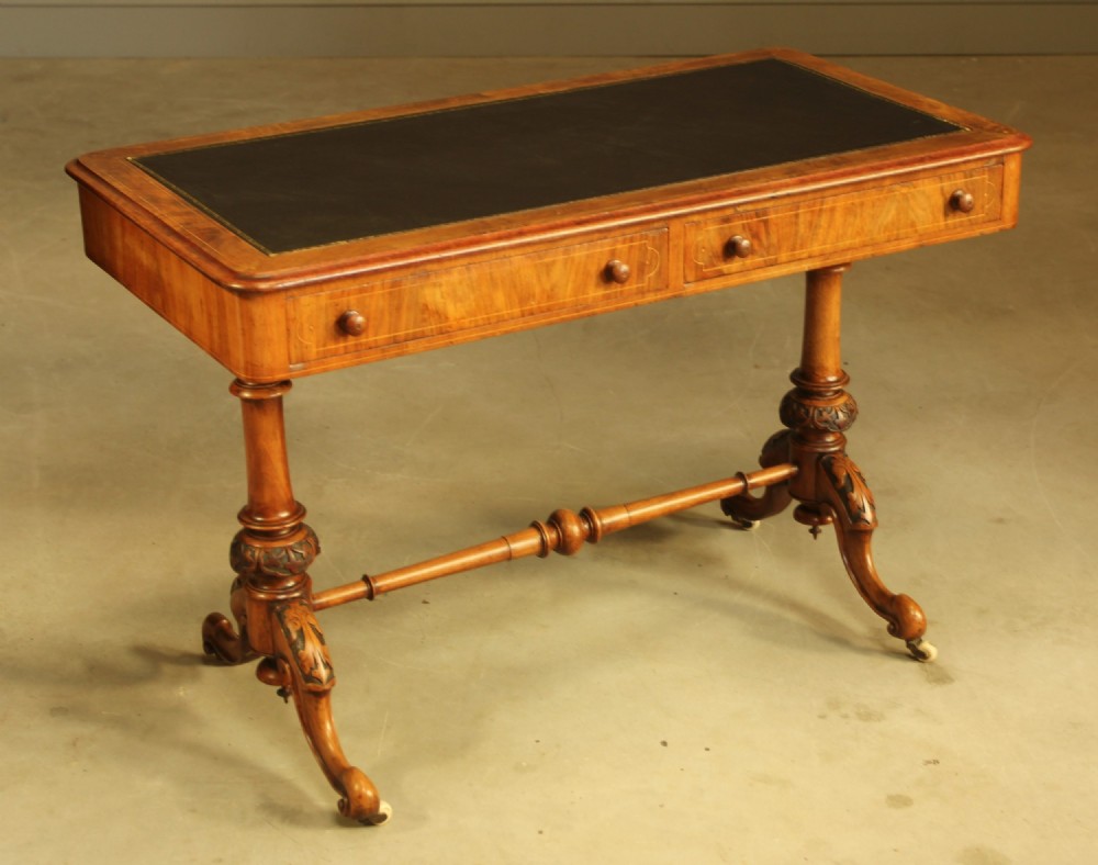 A Victorian walnut inlaid writing table.
