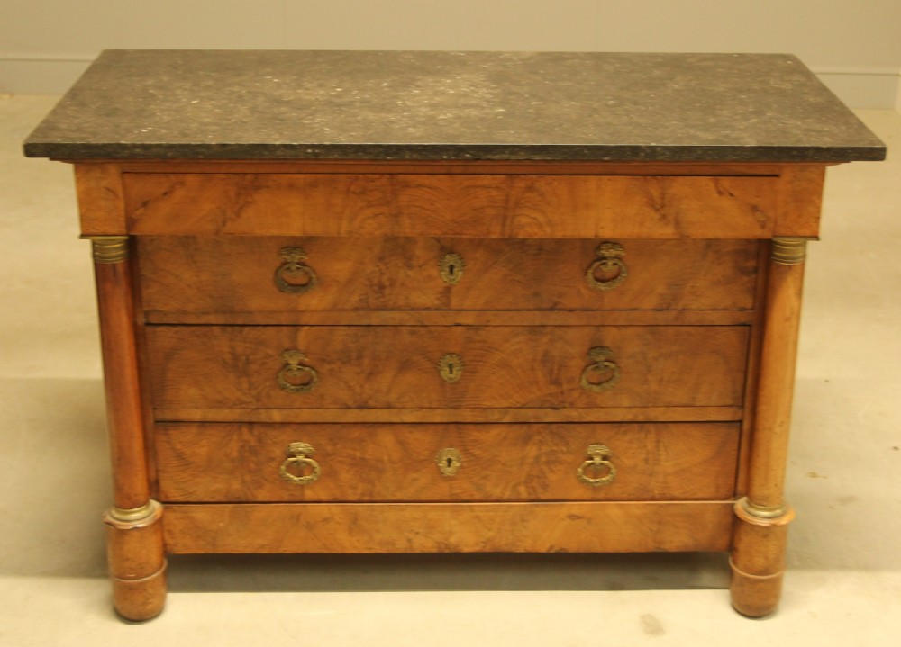 A 19th-century French burr walnut chest of drawers featuring three main drawers with brass ring handles, architectural side columns, and a dark marble top. View II
