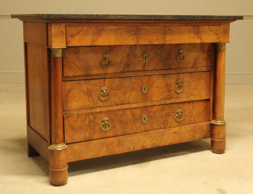 A 19th-century French burr walnut chest of drawers featuring three main drawers with brass ring handles, architectural side columns, and a dark marble top. View III