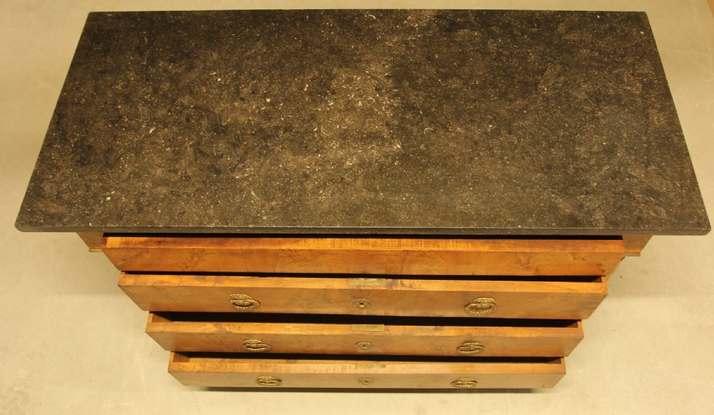 A 19th-century French burr walnut chest of drawers featuring three main drawers with brass ring handles, architectural side columns, and a dark marble top. View IX