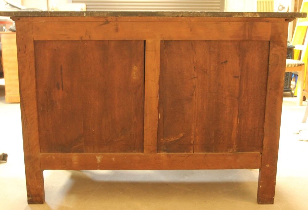 A 19th-century French burr walnut chest of drawers featuring three main drawers with brass ring handles, architectural side columns, and a dark marble top. View X