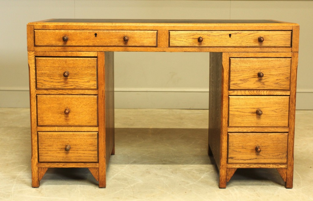 AN EARLY 20TH CENTURY HEALS STYLE OAK TWIN PEDISTAL DESK