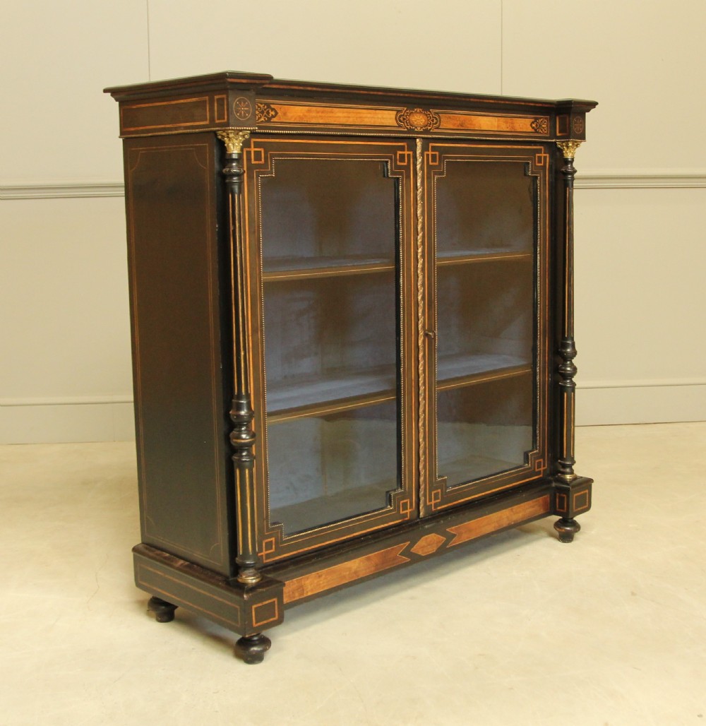 A Victorian Ebonized two door bookcase display 
