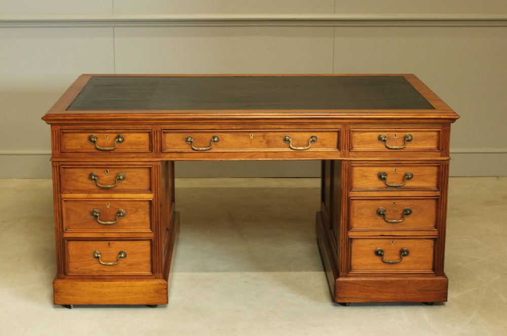 An early 20th century walnut twin pedestal writing desk.  View II