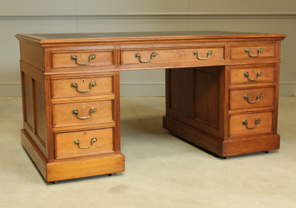 An early 20th century walnut twin pedestal writing desk.  View IV