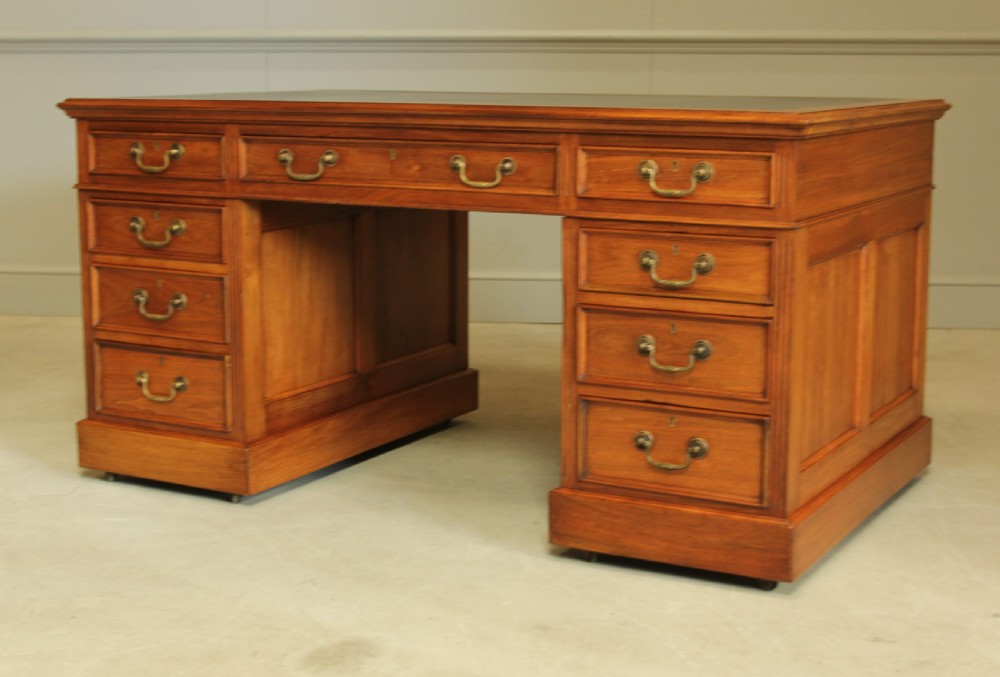 An early 20th century walnut twin pedestal writing desk.  View VI