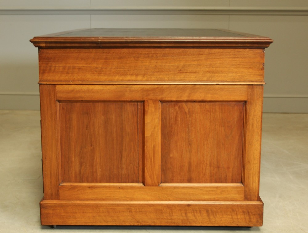 An early 20th century walnut twin pedestal writing desk.  View VIII
