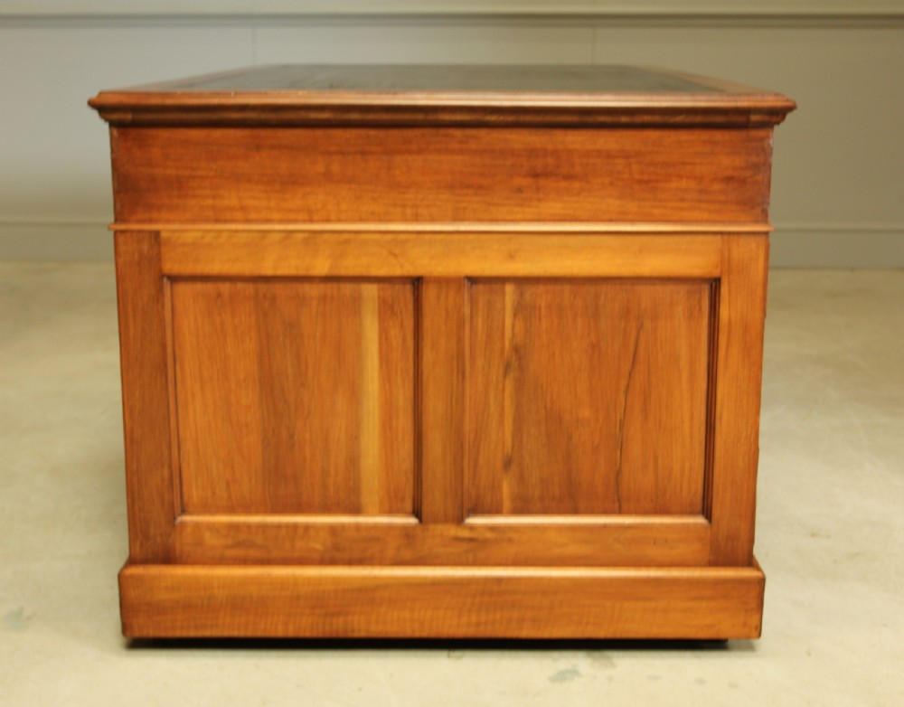 An early 20th century walnut twin pedestal writing desk.  View IX