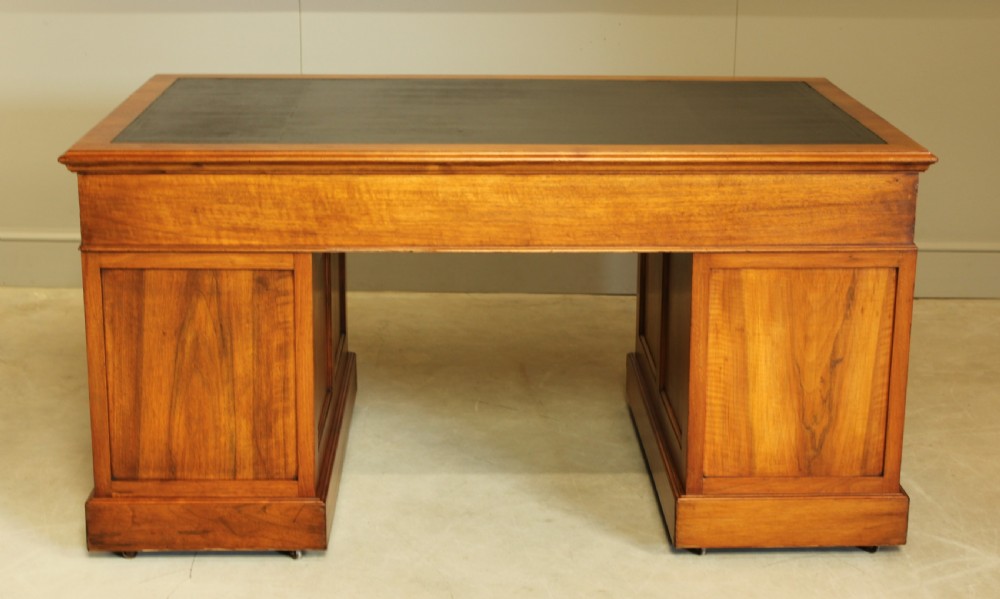 An early 20th century walnut twin pedestal writing desk.  View X