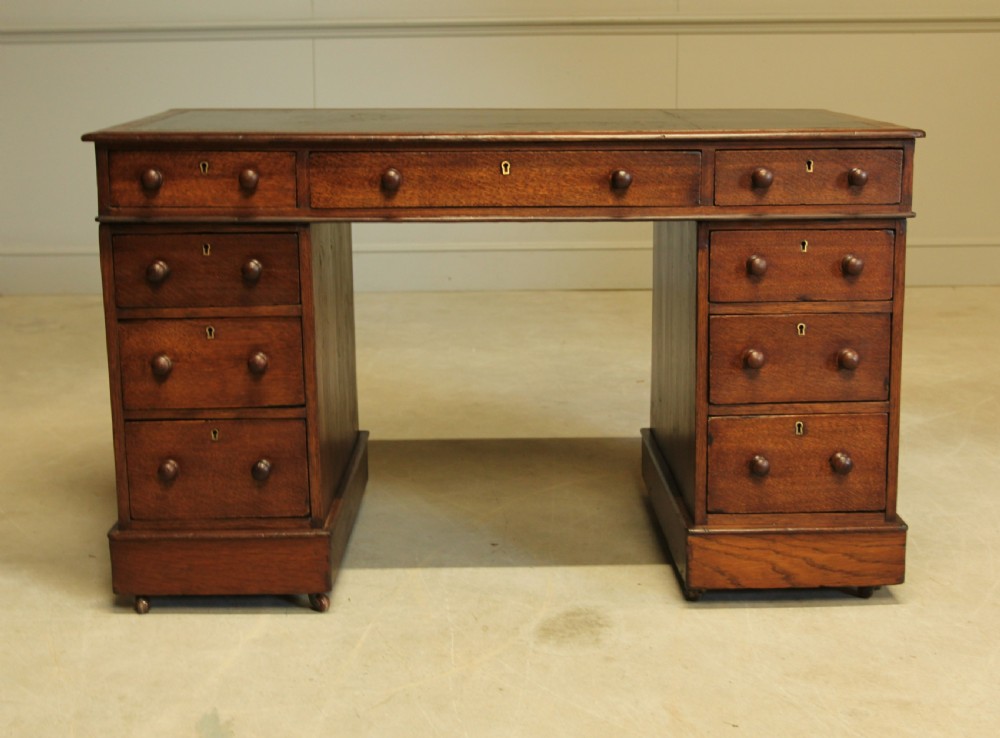 A 19th century Victorian oak twin pedestal writing desk. View II