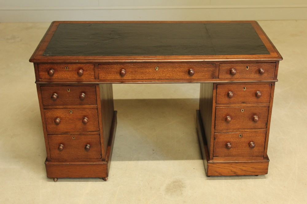 A 19th century Victorian oak twin pedestal writing desk. View III