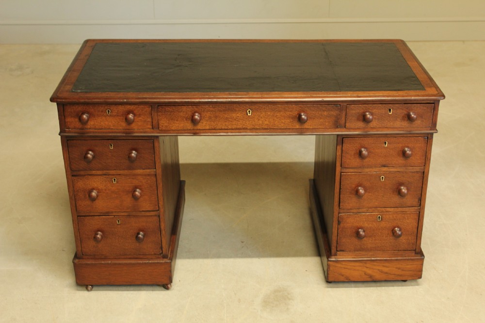 A 19th century Victorian oak twin pedestal writing desk. View IV