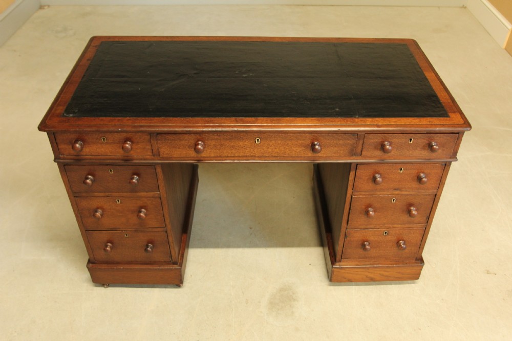 A 19th century Victorian oak twin pedestal writing desk. View V