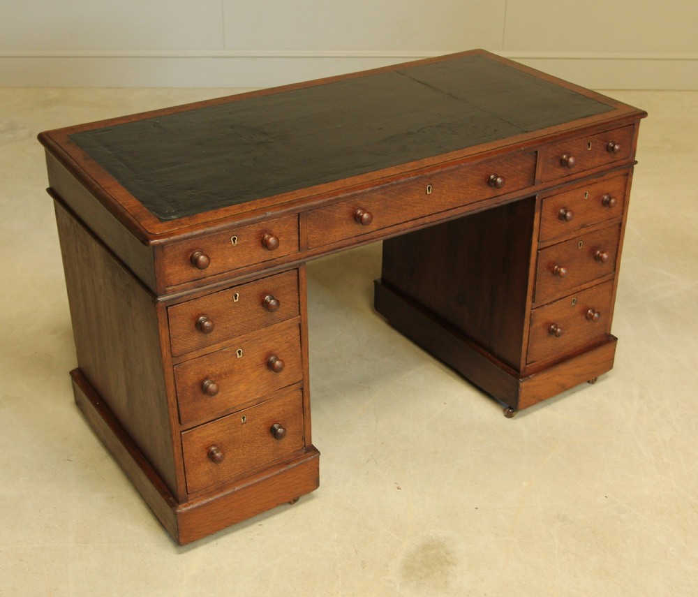 A 19th century Victorian oak twin pedestal writing desk. View VI