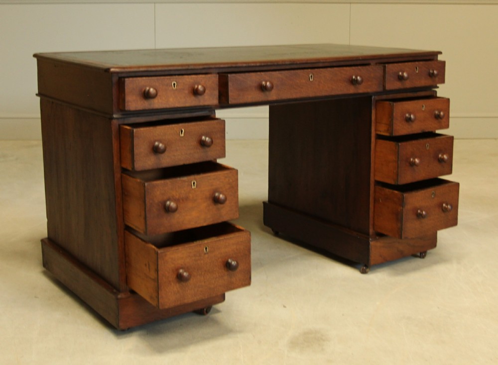 A 19th century Victorian oak twin pedestal writing desk. View VIII