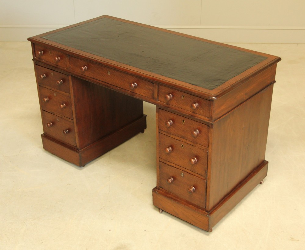 A 19th century Victorian oak twin pedestal writing desk. View XI