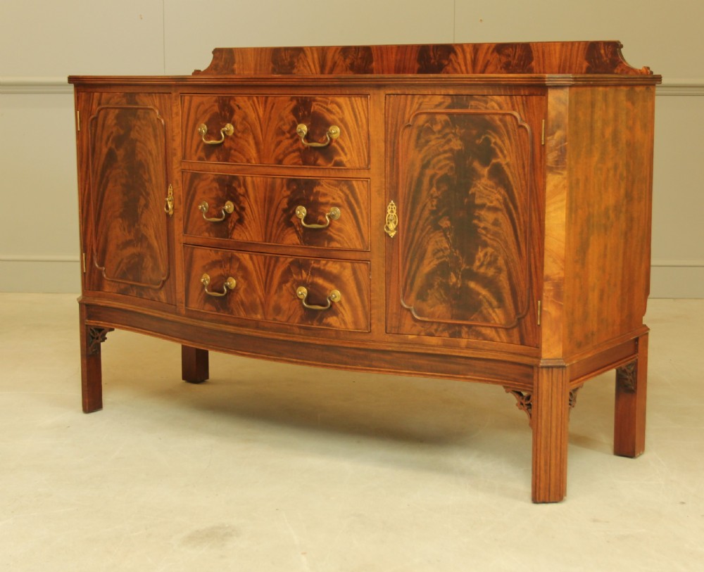 An early 20th century curl mahogany serpentine sideboard. View III