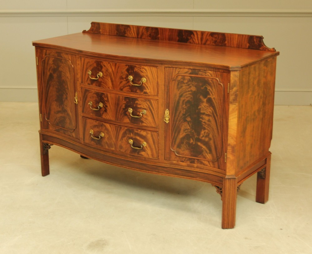 An early 20th century curl mahogany serpentine sideboard. View V