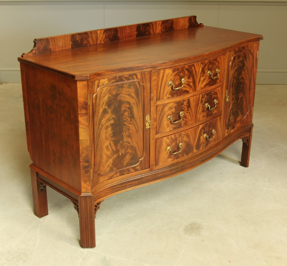 An early 20th century curl mahogany serpentine sideboard. View VI