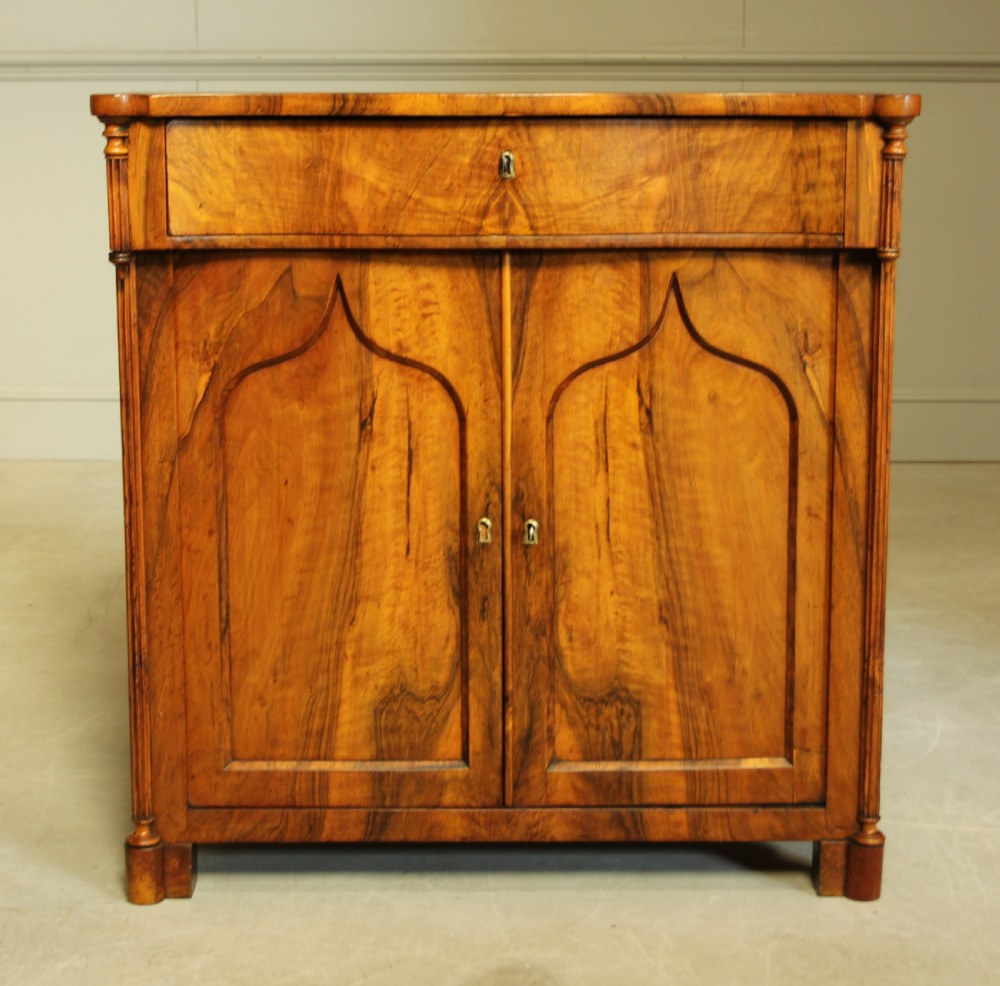 A Serpentine 19th century French Walnut two door sideboard.