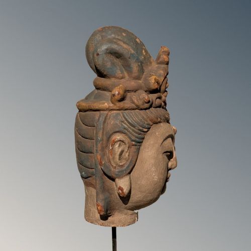 A carved wooden head of a Buddhist deity featuring an ornate tall crown, serene facial features, and residual surface pigments. View III