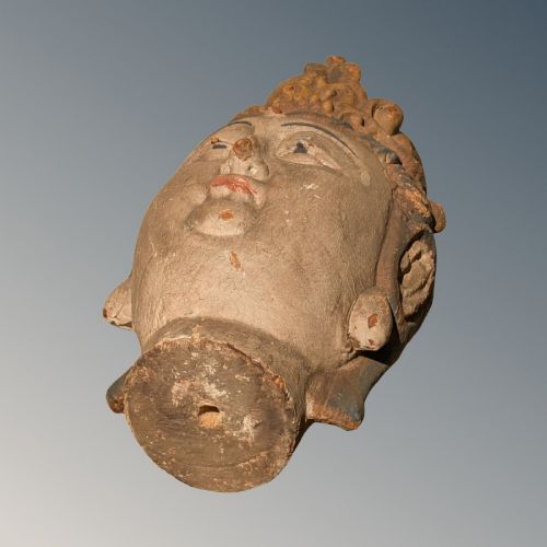 A carved wooden head of a Buddhist deity featuring an ornate tall crown, serene facial features, and residual surface pigments. View VI