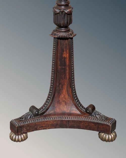 fig 1. A dark rosewood Regency standard lamp featuring a barley twist column, a carved triform base with brass feet, and a cream fabric shade.