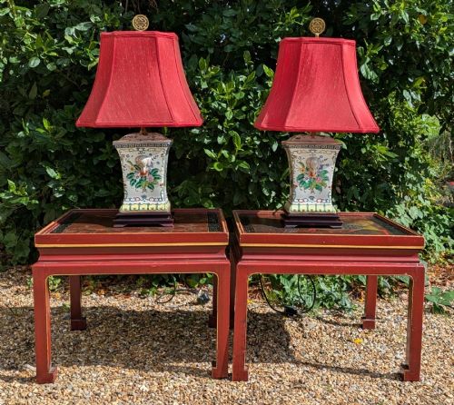 fig 1. A pair of Chinese porcelain table lamps featuring hand-painted floral motifs and relief elephant details, topped with red silk shades.
