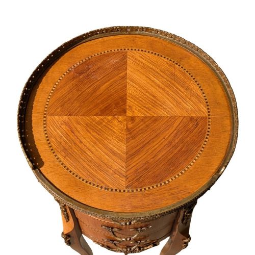 A circular French-style bedside cabinet crafted from inlaid kingwood, featuring three drawers, brass mounts, a top gallery rim, and cabriole legs. View IV