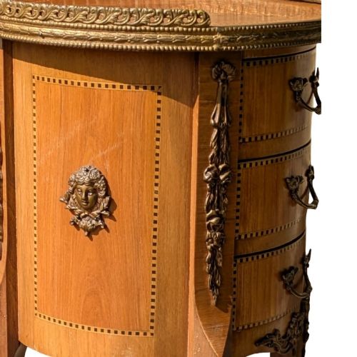 A circular French-style bedside cabinet crafted from inlaid kingwood, featuring three drawers, brass mounts, a top gallery rim, and cabriole legs. View V