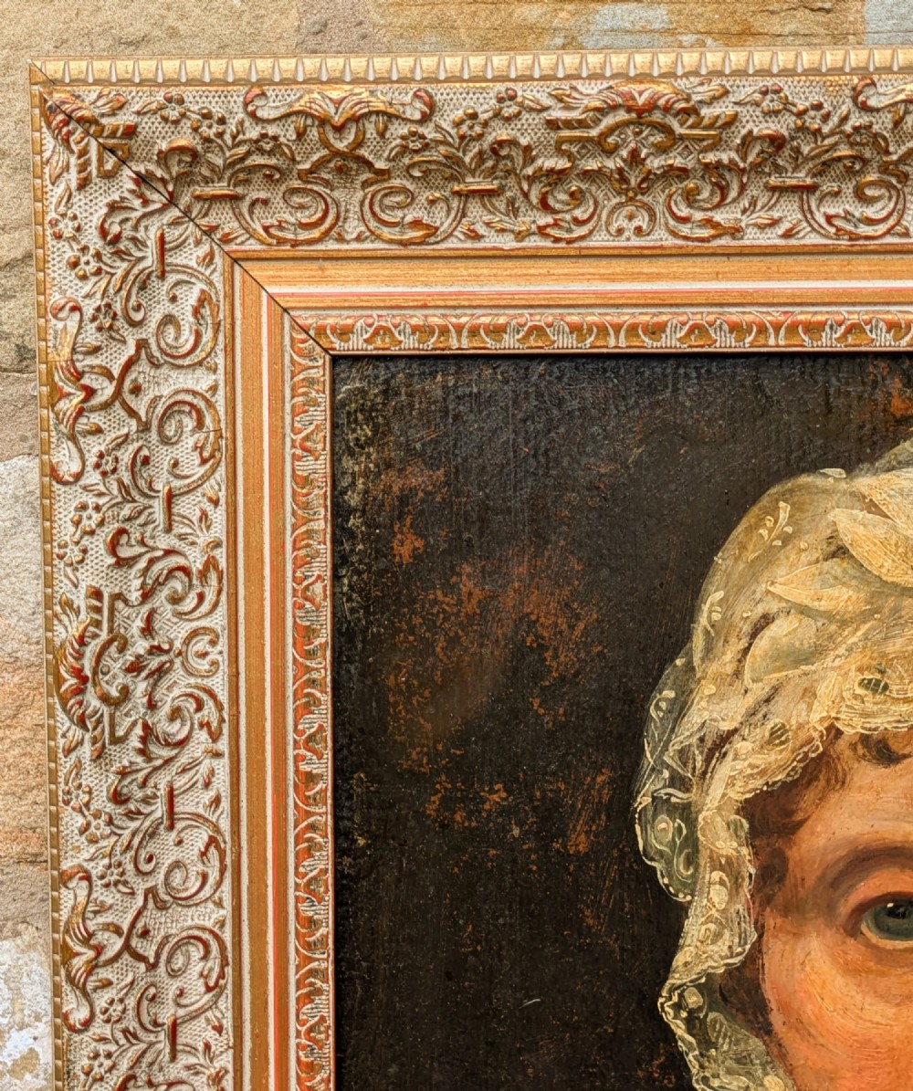 An antique 19th-century oil portrait depicting an elderly woman in a lace cap and red patterned shawl, framed in a carved gilt wood frame. View VIII