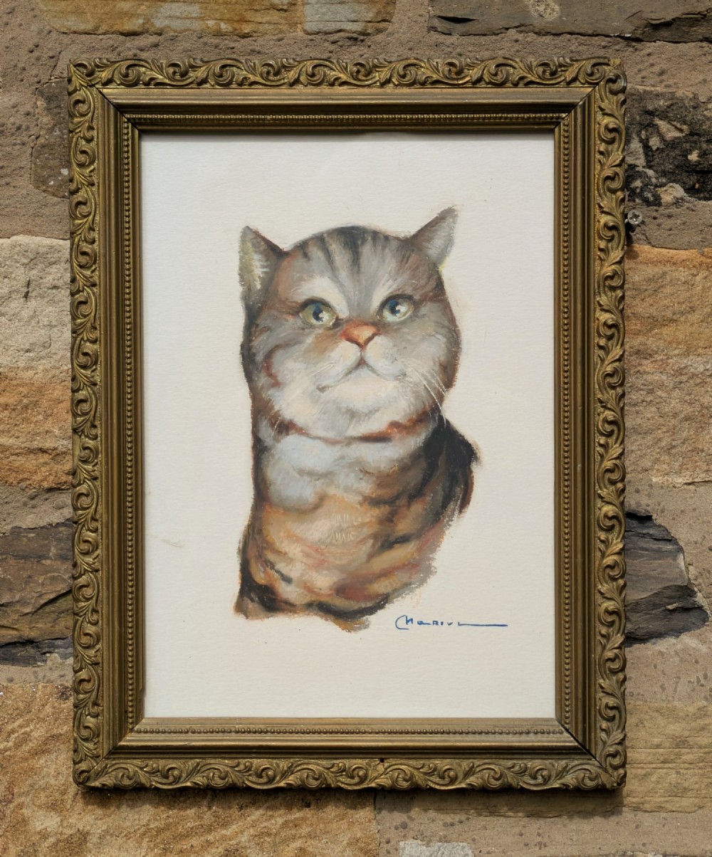 A framed pastel portrait depicting a grey and brown tabby cat set inside an ornate gold-coloured molded frame.