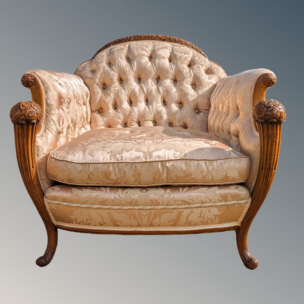 An antique French armchair featuring a carved walnut frame, button-tufted back, and champagne silk damask upholstery. View II