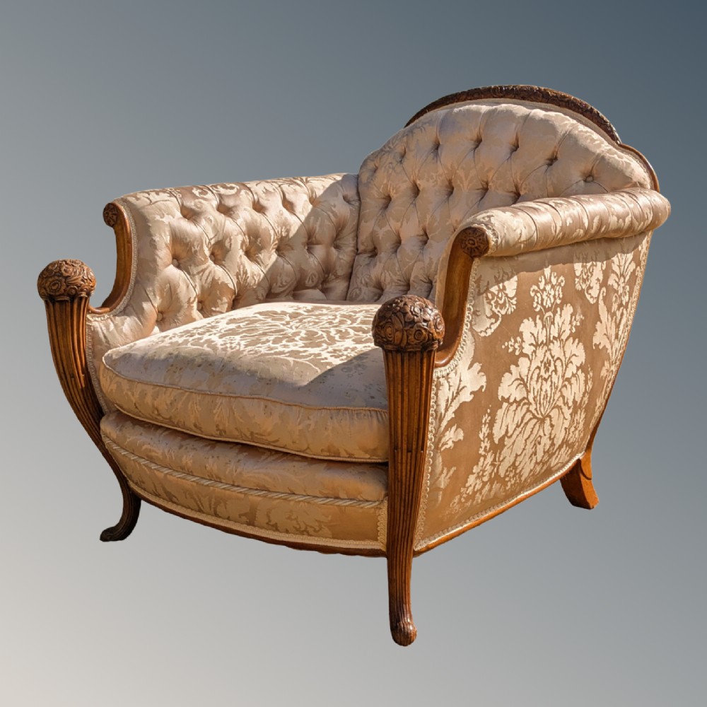 An antique French armchair featuring a carved walnut frame, button-tufted back, and champagne silk damask upholstery. View III