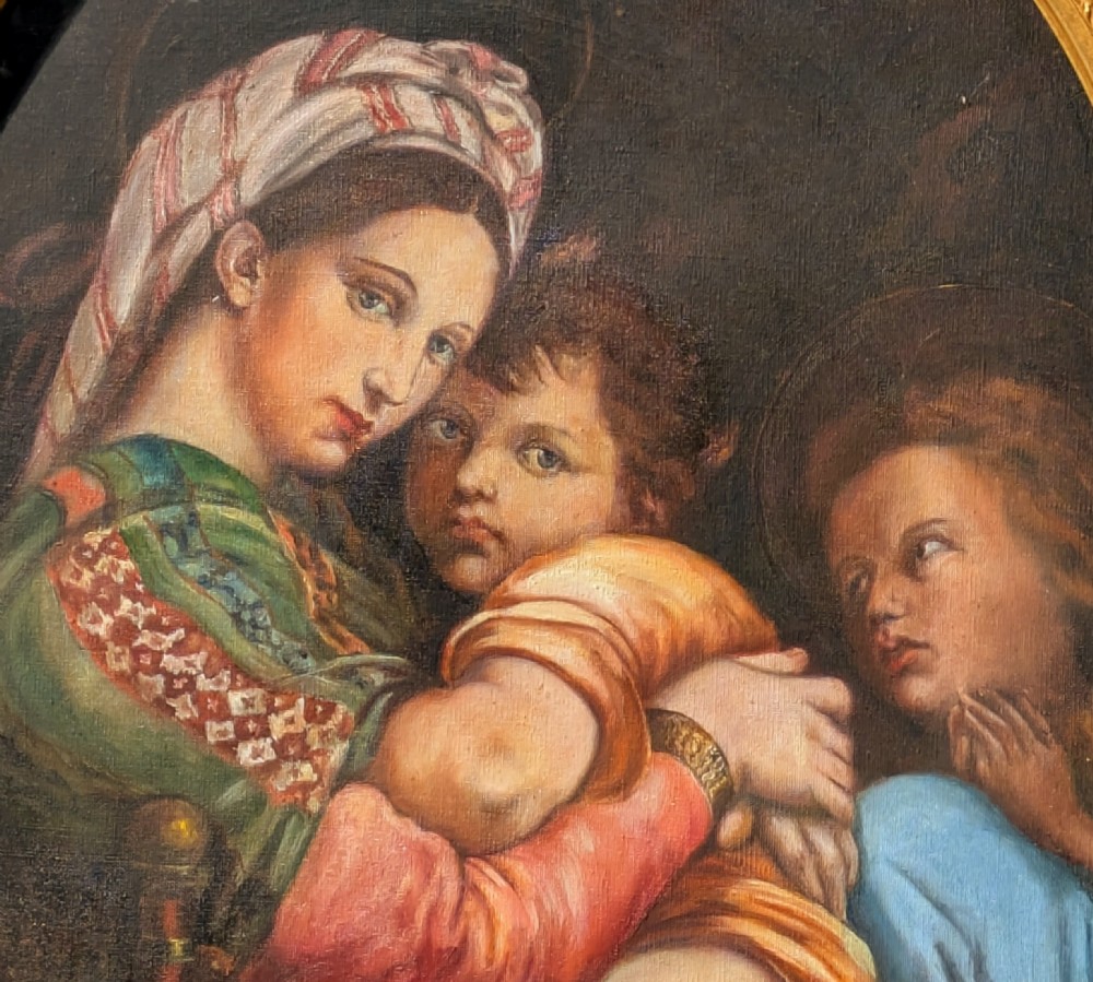 An oval oil painting depicting Mary holding the infant Christ alongside Saint John, set within an ornate gilded frame with corner fretwork. View III