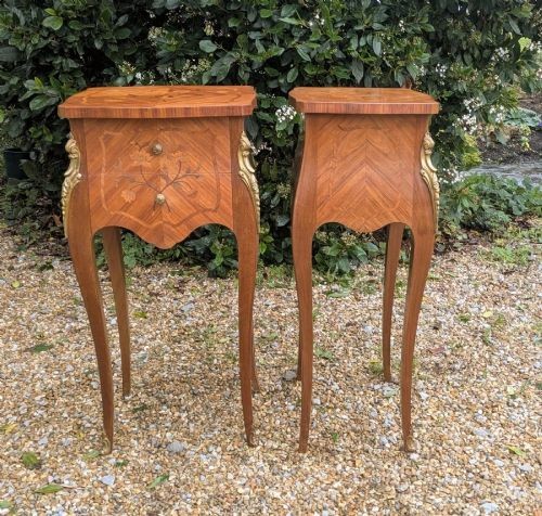 A pair of French Kingwood bedside cabinets featuring floral marquetry inlays, curved cabriole legs, and polished brass mounts. View II
