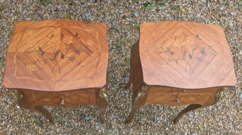 A pair of French Kingwood bedside cabinets featuring floral marquetry inlays, curved cabriole legs, and polished brass mounts. View IV
