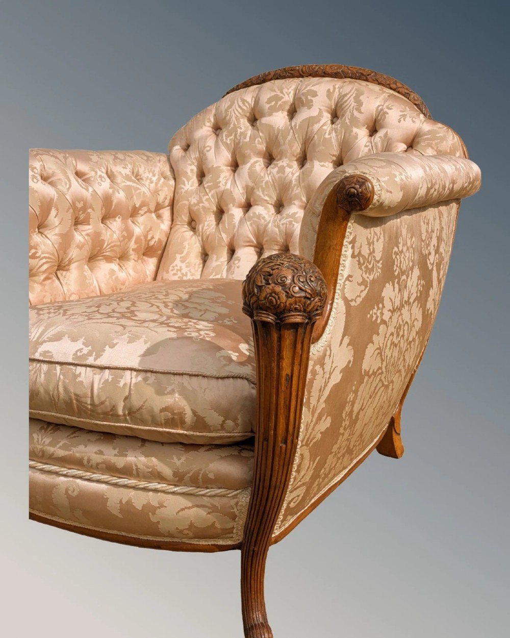 A pair of French armchairs with carved walnut frames and deep-buttoned champagne silk upholstery. View VIII