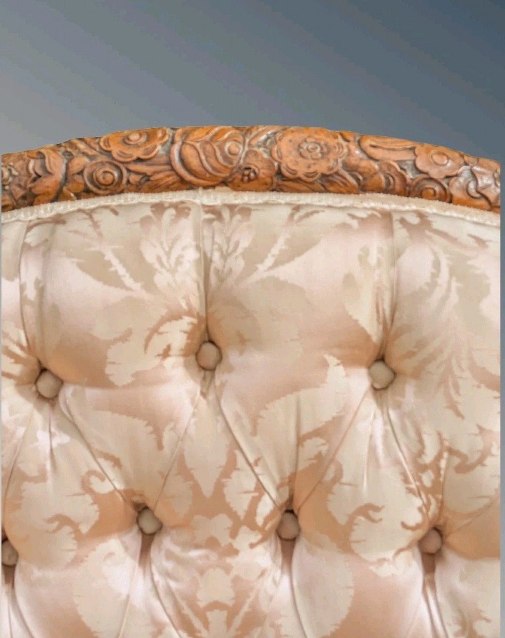 A pair of French armchairs with carved walnut frames and deep-buttoned champagne silk upholstery. View X