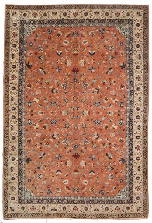 An antique hand-knotted Tabriz carpet featuring a terracotta central field decorated with intricate floral motifs and framed by layered ivory and navy decorative borders.