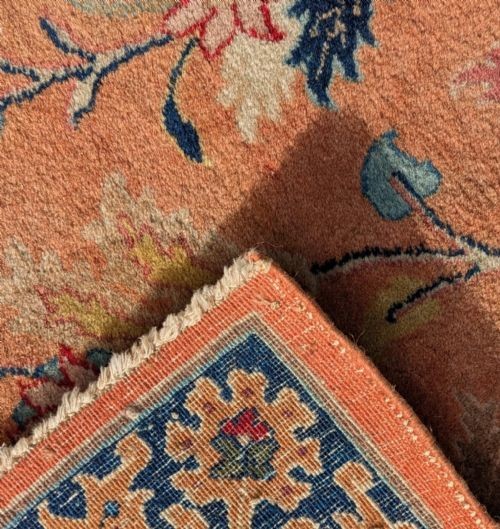 An antique hand-knotted Tabriz carpet featuring a terracotta central field decorated with intricate floral motifs and framed by layered ivory and navy decorative borders. View VI