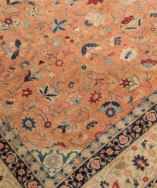 An antique hand-knotted Tabriz carpet featuring a terracotta central field decorated with intricate floral motifs and framed by layered ivory and navy decorative borders. View VII