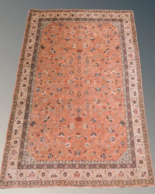 An antique hand-knotted Tabriz carpet featuring a terracotta central field decorated with intricate floral motifs and framed by layered ivory and navy decorative borders. View VIII