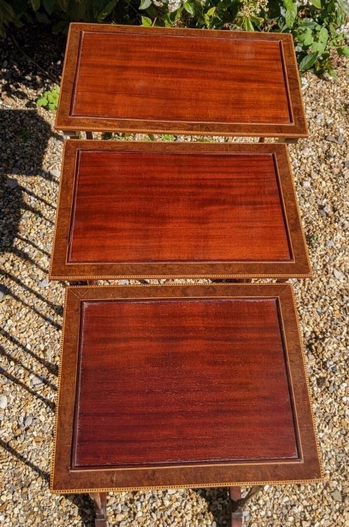 A set of three graduated Regency mahogany nesting tables featuring slender turned legs, curved stretchers, and sledge feet. View IV