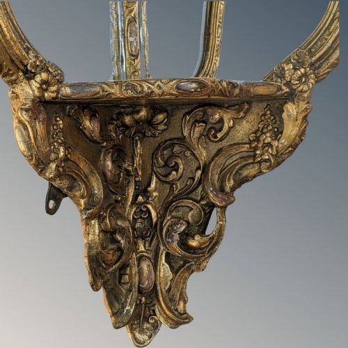 An ornate Rococo gilded wood wall bracket featuring mirrored back panels, serpentine frame, and decorative carved scrollwork. View II