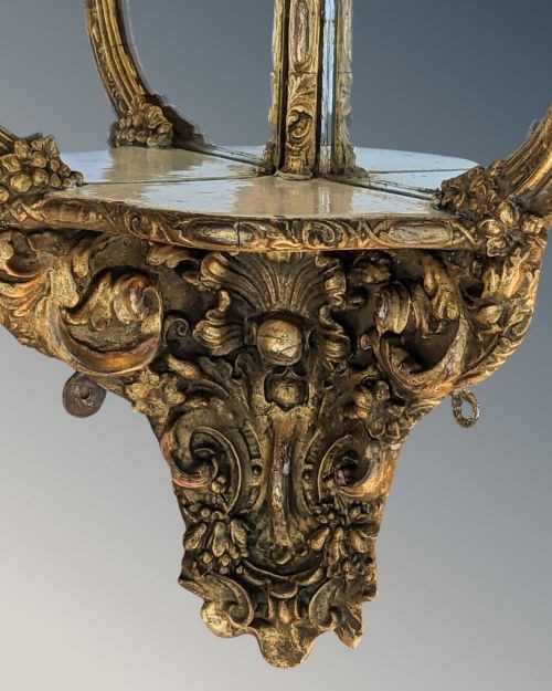 An ornate Rococo gilded wood wall bracket featuring mirrored back panels, serpentine frame, and decorative carved scrollwork. View III